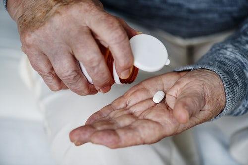 man taking a supplement pill